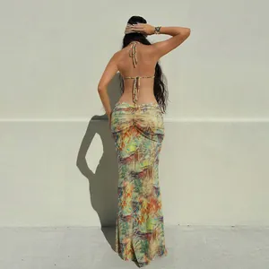 Back view of a colorful halter neck backless dress with ruched details for a slim fit style.