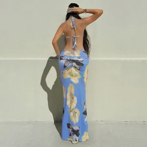 Rear view of a sexy blue floral halter neck backless maxi dress with tie-up design details.