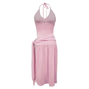 Back view of a pink halter neck top and wrap skirt set with elegant fabric drape