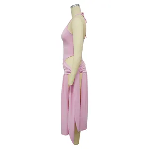 Side view of pink two-piece set featuring halter top and tie-waist high slit skirt