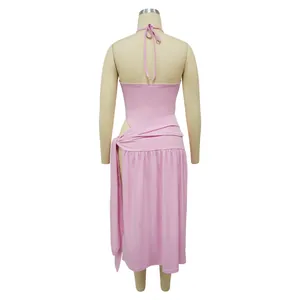 Back view of pink halter neck top and side-slit midi skirt set on mannequin