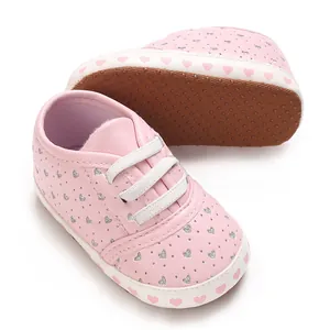 Detailed view of pink baby walking shoes with heart pattern and soft non-slip sole
