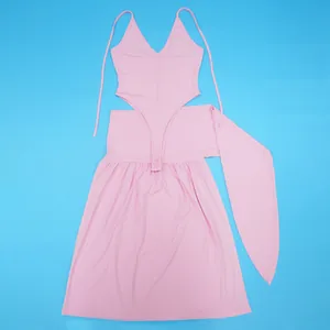 Detailed view of pink two-piece set featuring bodysuit and tie-up split skirt.