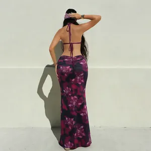 Detail view from the back of a sexy backless floral halter maxi dress with slim fit