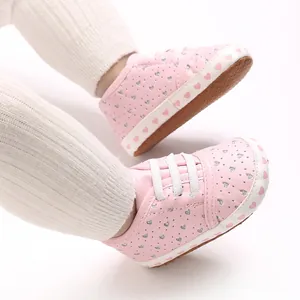 Close-up of pink baby walking shoes with heart pattern and soft non-slip soles
