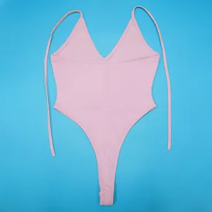 High-quality close-up detail of a light pink high-cut one-piece swimsuit with adjustable tie straps