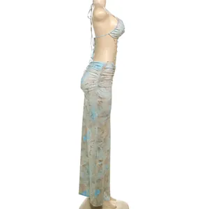 Detailed side view of sexy backless halter dress with ruched details and bead chains.
