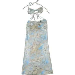 Macro detail of the sexy backless halter dress featuring bead chain and cloud print