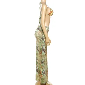 Side view of halter backless maxi dress with tropical print and delicate bead chains