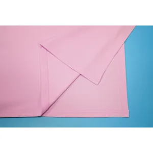 Detailed close-up of pink solid color skirt showing the side slit and stitching