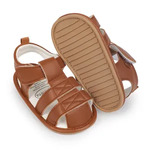 Close-up of brown baby sandals featuring a non-slip grooved rubber sole