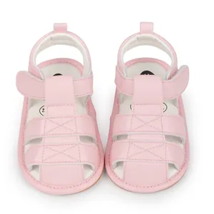 Top down view showing the breathable cut-outs and soft pink material of baby sandals