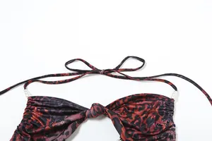 Close-up detail of leopard print halter neck dress with pearl chain decoration