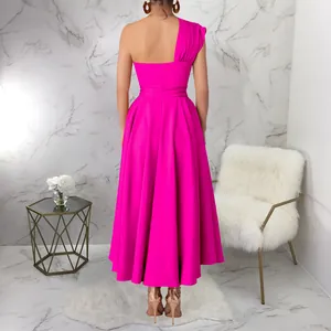 Back view of hot pink one-shoulder flared maxi dress with cinched waist for summer
