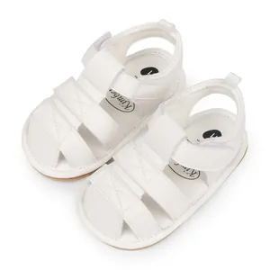 A detail view of breathable white baby sandals featuring soft anti-slip rubber soles
