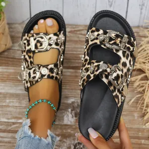 Detail view of leopard print platform sandals featuring metallic buckles and studs.