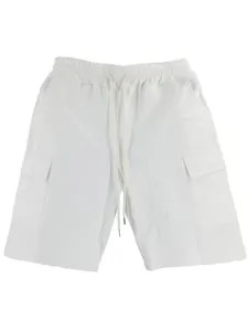 Detail of white linen cargo shorts showing drawstring waist and flap pocket design