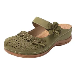 Vintage olive green women's mule slippers featuring elegant floral cutout and applique detail
