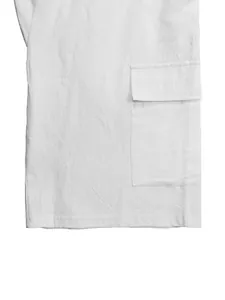 Close-up detail of white linen cargo shorts showing a side pocket and fabric texture