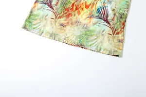 Detail shot of the hem and tropical leaf print on a sexy slim fit backless dress