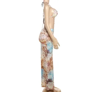 Side view detail of tropical print halter dress with bead chain and backless design