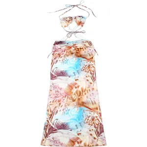 Detail view of tropical print halter neck dress with bead chain and tie strings