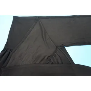Detailed macro view showing the black fabric texture and stitching of this slit skirt