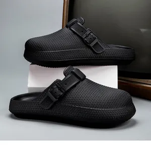 Detailed side view of black breathable EVA clogs with textured upper and buckle strap