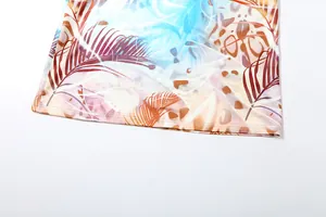 Detail view of slim sexy halter dress hem featuring vibrant tropical leopard print