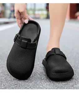 Close-up of black EVA clogs with textured surface and buckle strap details.
