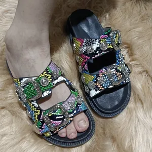 Women's platform sandals with vibrant snakeskin pattern and decorative metal buckles