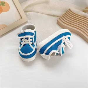 Close-up of blue and white children's canvas shoes with velcro strap and soft sole