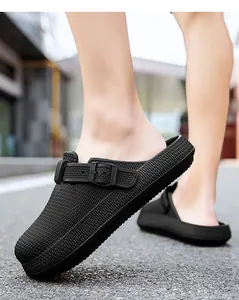 Detail close-up of black breathable EVA clogs with textured weave pattern and buckle.