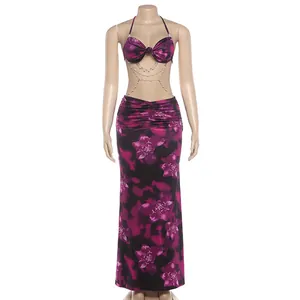 Close-up of floral halter maxi dress with pearl chain decoration and cutout waist