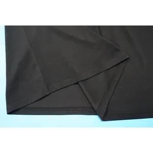 Detail shot of the hemline and slit stitching on a professional black solid skirt