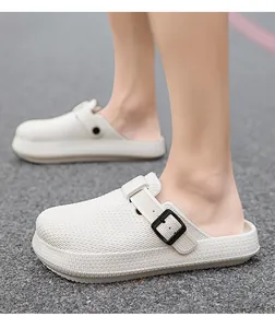 Detailed macro view of cream white breathable EVA clogs with an adjustable black buckle strap