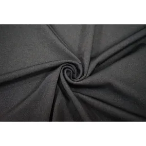 Macro detail of high-quality black fabric with fine knit texture and elegant drape