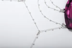 Detail view of exquisite pearl chain decoration on sexy halter backless dress for women