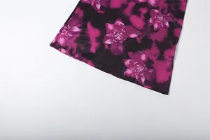 Detailed view showing the vibrant magenta orchid floral print and hem of the dress.