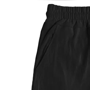 Close-up detailed view of black linen cargo shorts waistband and side pocket structure