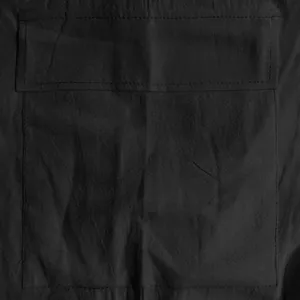 Close-up macro view showing detailed pocket stitching on black linen cargo shorts for men