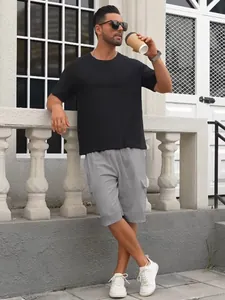 Lifestyle view of men's grey cargo shorts featuring large side pockets and drawstring.