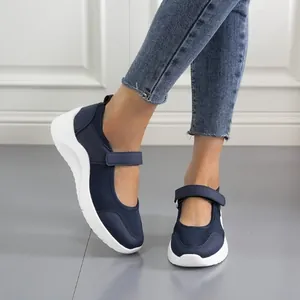 Navy blue women's wedge sneakers with mesh upper and velcro strap detail.