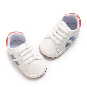 Top view of white soft-soled baby walking shoes with blue stripes and elastic laces