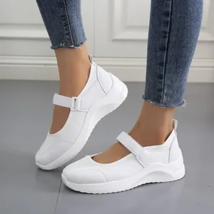 White women's platform casual sneakers with velcro strap shown in detail on feet