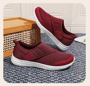 Close-up of breathable maroon mesh walking shoes with adjustable hook and loop strap