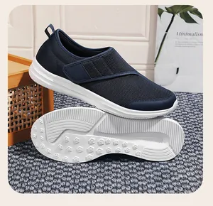 Close-up of navy blue breathable mesh walking shoes showing slip-resistant white outsole