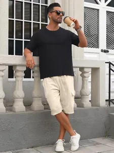 Full-body lifestyle view of men's cream cargo shorts with multi-pockets and drawstring.