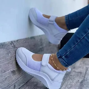 Stylish white wedge Mary Jane sneakers with breathable mesh and hook-and-loop strap.