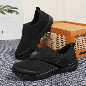 Breathable black mesh walking shoes for seniors with adjustable strap and comfort sole.